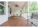 Covered porch with seating, wood flooring, and plenty of space for entertaining or enjoying outdoor living at 4840 Chase Ln, Cumming, GA 30040