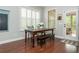 Bright dining area with large windows, a wooden table, and access to the patio or sunroom at 4840 Chase Ln, Cumming, GA 30040