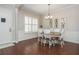 Bright dining room featuring hardwood floors, wainscoting, and stylish lighting at 4840 Chase Ln, Cumming, GA 30040
