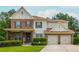 Charming two-story home featuring a manicured lawn, stone accents and a two-car garage at 4840 Chase Ln, Cumming, GA 30040