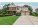 Traditional two-story home boasts manicured landscaping, brick and siding exterior, and a two-car garage at 4840 Chase Ln, Cumming, GA 30040