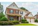Traditional two-story home boasts manicured landscaping, brick and siding exterior, and a two-car garage at 4840 Chase Ln, Cumming, GA 30040