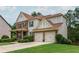 Traditional two-story home boasts manicured landscaping, brick and siding exterior, and a two-car garage at 4840 Chase Ln, Cumming, GA 30040