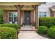Inviting front porch with stone facade, decorative wreath, and landscaped surroundings at 4840 Chase Ln, Cumming, GA 30040