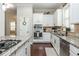 Well-equipped kitchen featuring granite countertops, stainless steel appliances, and white cabinetry at 4840 Chase Ln, Cumming, GA 30040
