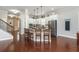 Bright kitchen with white cabinets, stainless steel appliances, large island, and hardwood floors at 4840 Chase Ln, Cumming, GA 30040