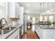 Open-concept kitchen with granite countertops, stainless steel appliances, and an adjoining living area at 4840 Chase Ln, Cumming, GA 30040