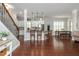 Open-concept living room featuring hardwood floors, kitchen island, and staircase at 4840 Chase Ln, Cumming, GA 30040