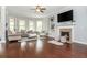 Comfortable living room with hardwood floors, fireplace, and built-in shelving at 4840 Chase Ln, Cumming, GA 30040