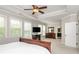 Spacious main bedroom featuring tray ceilings, large windows, neutral colors, and access to main bathroom at 4840 Chase Ln, Cumming, GA 30040