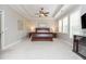 Spacious main bedroom featuring tray ceilings, large windows, neutral colors, and a ceiling fan at 4840 Chase Ln, Cumming, GA 30040