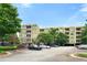 Multi-story condo building with parking, mature trees, and a manicured lawn at , Atlanta, GA 30313
