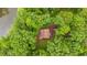 Aerial view of a home secluded by lush greenery, showing the peaceful, wooded setting at 15 Bailey St, Whitesburg, GA 30185