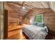 Attic featuring a game room, bedroom, wood walls, sloped ceiling and wood floors at 15 Bailey St, Whitesburg, GA 30185