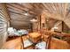 Attic featuring a game room, bedroom, fireplace, wood walls, sloped ceiling and wood floors at 15 Bailey St, Whitesburg, GA 30185