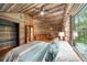Attic featuring a game room, bedroom, wood walls, sloped ceiling and wood floors at 15 Bailey St, Whitesburg, GA 30185