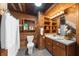 Bathroom featuring wood walls, a corner toilet, vanity with storage, and a shower with a curtain at 15 Bailey St, Whitesburg, GA 30185