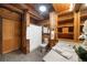 Bathroom with wood walls, a corner toilet, a vanity with storage, and a shower with a curtain at 15 Bailey St, Whitesburg, GA 30185