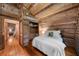Cozy bedroom featuring wood walls, sloped ceiling, a closet and wood floors at 15 Bailey St, Whitesburg, GA 30185
