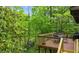 Deck overlooking a lush green canopy provides a relaxing outdoor dining space at 15 Bailey St, Whitesburg, GA 30185