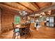 Open concept dining area adjacent to the kitchen in a rustic log home at 15 Bailey St, Whitesburg, GA 30185