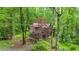 Charming log cabin nestled amongst beautiful trees and greenery on a landscaped lot at 15 Bailey St, Whitesburg, GA 30185