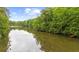 Scenic view of the lake with lush greenery, docks, and boat access; beautiful waterfront property at 15 Bailey St, Whitesburg, GA 30185