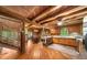 Spacious living area with hardwood floors, wood walls, and an open kitchen at 15 Bailey St, Whitesburg, GA 30185