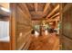 Warm living space features hardwood floors, log walls, and an open staircase at 15 Bailey St, Whitesburg, GA 30185
