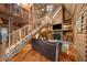 Spacious log cabin living room with vaulted ceilings, fireplace, and staircase at 15 Bailey St, Whitesburg, GA 30185