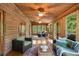 Wood-paneled sun room offers a relaxing atmosphere, ceiling fans, and natural light at 15 Bailey St, Whitesburg, GA 30185