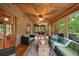 Sun room with wood paneling, hardwood floors, ceiling fans and views of nature at 15 Bailey St, Whitesburg, GA 30185