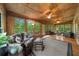 Spacious sun room has many windows, multiple seating areas, and hardwood floors at 15 Bailey St, Whitesburg, GA 30185