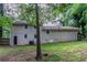 Exterior view of the home's backyard, showing the siding, AC unit, and wooden fence at 1539 Pine Glen Cir, Decatur, GA 30035