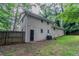 Back exterior view showing the siding, windows, door, and AC unit, complemented by the backyard at 1539 Pine Glen Cir, Decatur, GA 30035