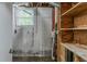 Unfinished basement area featuring utilities, a window, and wooden shelves at 1539 Pine Glen Cir, Decatur, GA 30035