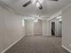 Large carpeted basement area featuring a window, ceiling fan, and access to stairs and a closet at 1539 Pine Glen Cir, Decatur, GA 30035
