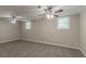 Spacious carpeted basement with two windows and dual ceiling fans providing ample lighting and comfort at 1539 Pine Glen Cir, Decatur, GA 30035