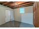 Unfinished basement featuring painted concrete walls, an exterior door, and a window at 1539 Pine Glen Cir, Decatur, GA 30035
