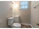 Cozy bathroom featuring a toilet, vanity, mirror, lighting, and a small window at 1539 Pine Glen Cir, Decatur, GA 30035