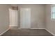 This carpeted bedroom includes a closet and a window letting in natural light at 1539 Pine Glen Cir, Decatur, GA 30035