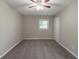 This carpeted bedroom includes a ceiling fan and a window letting in natural light at 1539 Pine Glen Cir, Decatur, GA 30035