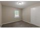 This carpeted bedroom includes a closet and a window letting in natural light at 1539 Pine Glen Cir, Decatur, GA 30035