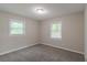 This carpeted bedroom includes two windows for lots of natural light at 1539 Pine Glen Cir, Decatur, GA 30035