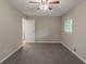 This carpeted bedroom includes a closet and a window letting in natural light at 1539 Pine Glen Cir, Decatur, GA 30035