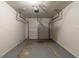 Clean garage featuring a white door, high ceiling, and painted concrete floor at 1539 Pine Glen Cir, Decatur, GA 30035