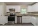 Updated kitchen with white cabinets, stainless steel appliances, and laminate countertops at 1539 Pine Glen Cir, Decatur, GA 30035
