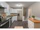 Modern kitchen featuring white cabinets, stainless steel appliances, and stone countertops at 1539 Pine Glen Cir, Decatur, GA 30035