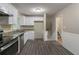 Modern kitchen with new appliances and gray vinyl flooring at 1539 Pine Glen Cir, Decatur, GA 30035