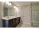 Bathroom with a double sink vanity and large mirror, plus access to a shower with glass door at 1949 Townsend Ne Ct # 22, Atlanta, GA 30329